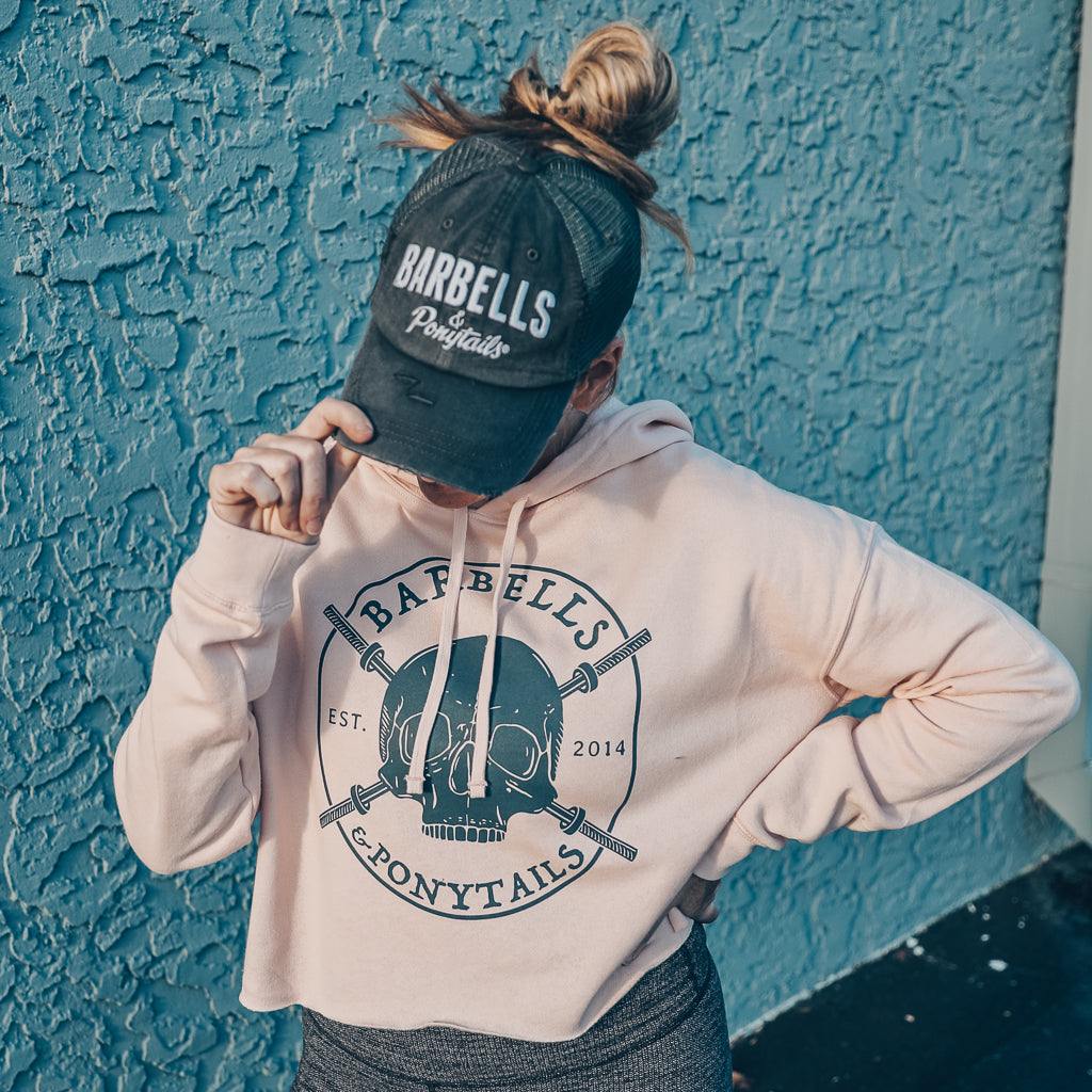 blush crop hoodie with grey skulls and barbells design
