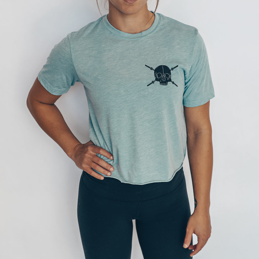 blue crop tee with black skulls and barbells design