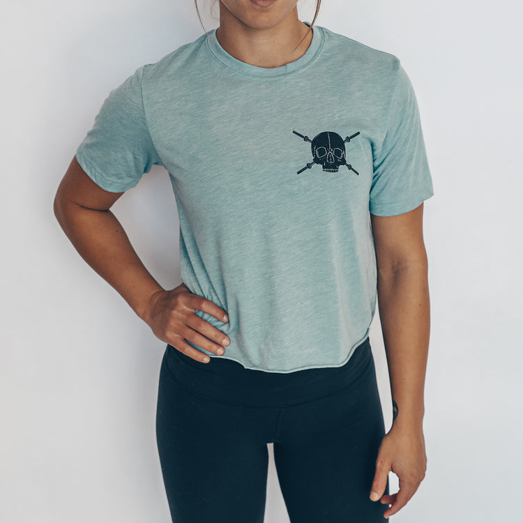 blue crop tee with black skulls and barbells design
