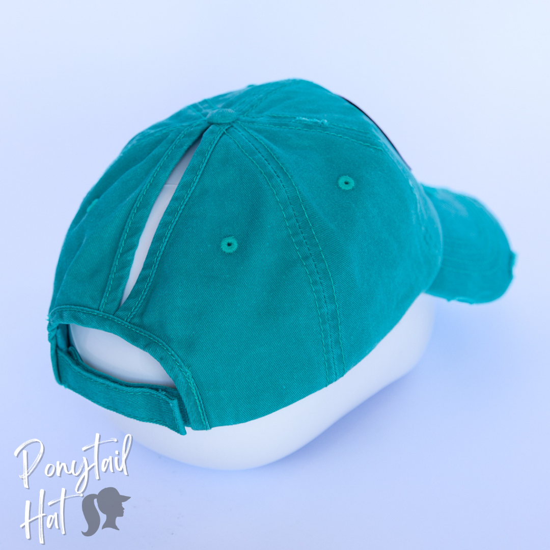 solid aqua ponytail hat with barbells and ponytails text